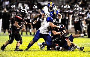 Radford quarterback Cody Lui-Yuen was sacked by Kaiser's Vili Fisiiahi in a game in 2014. Photo by Bruce Asato/Star-Advertiser.
