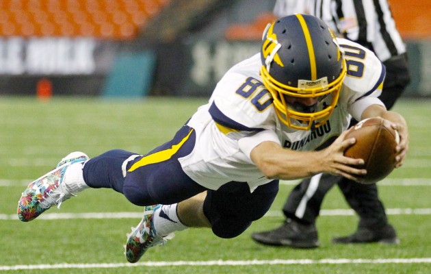 Punahou wide receiver Judd Cockett dove across the goal line to score a touchdown against Kamehameha in a game on Thursday at Aloha Stadium.  Photo by George F. Lee/Star-Advertiser.