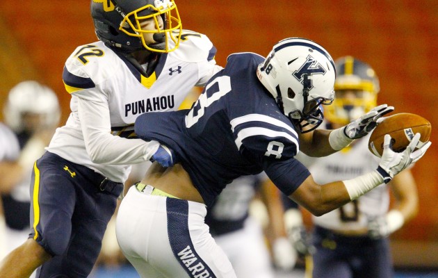 Kamehameha receiver Matthew Aio hung on to a pass as Punahou's Aaron Woo defended on the play in a game earlier this month. Photo by George F. Lee/Star-Advertiser.