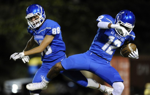 Moanalua’s Ethan Feguis-Tavares and Isaiah Jackson celebrated Jackson's interception for a touchdown in the first quarter of a game against Kaiser last week. Bruce Asato/Star-Advertiser.