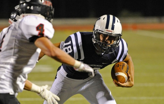 Kamehameha's Thomas Yam rushed for one of his two touchdowns in a 50-20 win over 'Iolani on Saturday. Photo by Bruce Asato/Star-Advertiser.