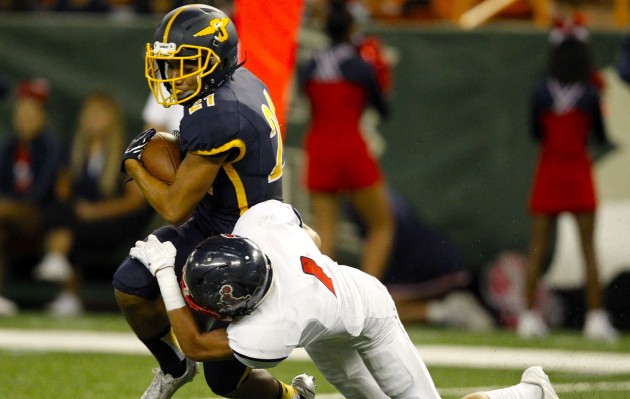 2016 September 9 SPT - HSA Photo by Jamm Aquino. Punahou wide receiver Ethan Takeyama (21) finds the end zone for a touchdown ahead of Saint Louis defensive back Kama Moore (1) during the first half of an ILH football game between the Punahou Buffanblu and the Saint Louis Crusaders on Friday, September 9, 2016 at Aloha Stadium in Halawa.