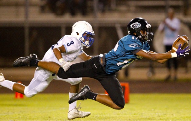 Kapolei receiver Marquis Montgomery caught a ball in front of Kailua DB Bruddah Spencer-Choy Foo. Photo by Jamm Aquino/Star-Advertiser.