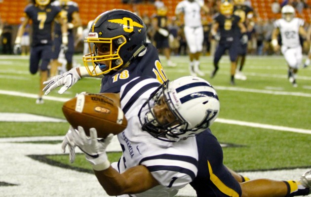 Punahou safety Kaulana Makaula broke up a pass intended for Kamehameha's Jaykob Cabunoc in the end zone during the first half of a game on Sept. 23. Photo by Jamm Aquino/Star-Advertiser.