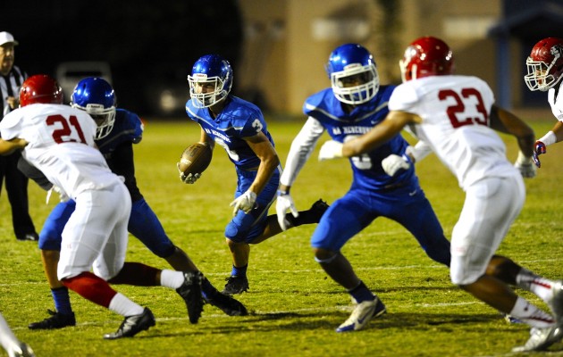 Moanalua's Brandon Bender looked for running room against Kahuku. Photo by Bruce Asato/Star-Advertiser.