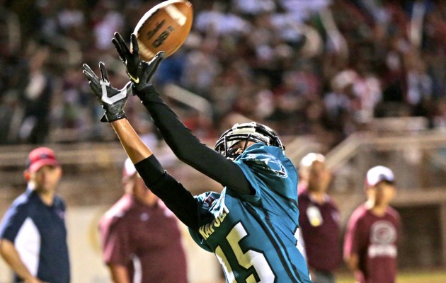 Kapolei's Kaeo Alvarez-Ranan made an over-the-shoulder catch for a touchdown in Friday night's OIA Red title-clinching 28-7 victory over Farrington. Both head coaches believe that Kapolei's decision to run the ball at the Govs' 3 with less than a minute left was not a case of running up the score. Jamm Aquino / Honolulu Star-Advertiser.
