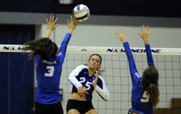 Anuenue's Kamalei Krug hit past two Moanalua blockers in a game on Wednesday night. Photo by Bruce Asato/Star-Advertiser.
