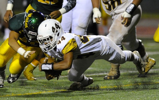 2016 September 30 SPT - HSA Photo by Bruce Asato  - Mililani’s Kaine Park recovers the football after it was knocked loose on the play in the first quarter of the Mililani vs Leilehua football game at Leilehua's Hugh Yoshida Stadium, Friday, September 30, 2016.