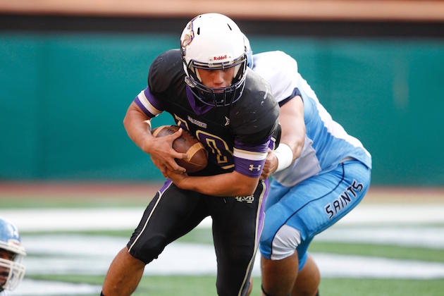 Damien QB Marcus Faufata-Pedrina fought off some early pressure to throw for a TD and run for another in the first half against St. Francis. Jamm Aquino/Star-Advertiser.