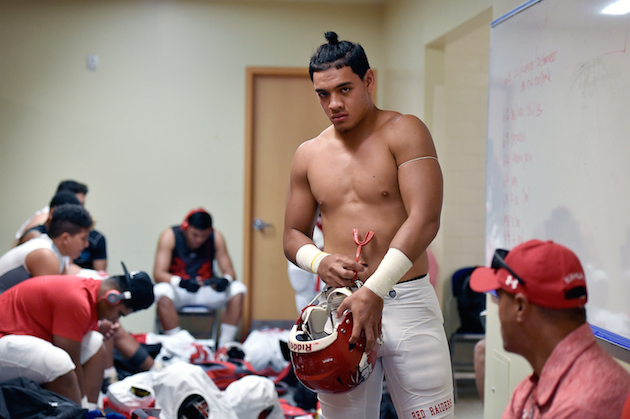 Kahuku's Kesi Ah-Hoy got ready in the locker room prior to a game against No. 1 Bishop Gorman in Las Vegas. Photo by David Becker/Special to the Star-Advertiser.