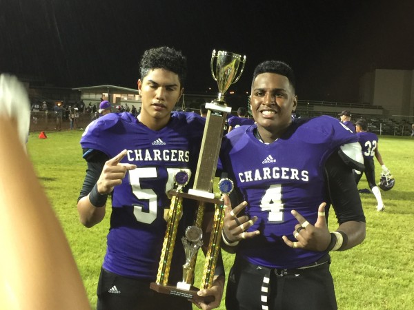 Offensive lineman Jeremiah Perifanos-Taamu and defensive lineman Zion Tupuola-Fetui were among the Chatgers who took turns posing with the newly made trophy commemorating the Pearl City-Waipahu Cup.