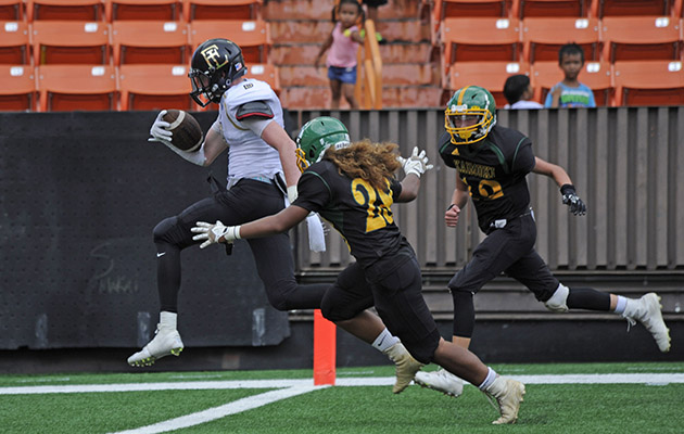 Faith Lutheran's Elijah Kothe made it into the end zone on a 19-yard touchdown pass from Sagan Gronauer on Sunday before Kaimuki's Winslow Sellet and Scout Cruikshank could close in. Bruce Asato / Honolulu Star-Advertiser.