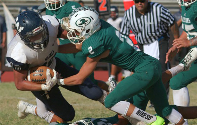 Kapaa's Edward Bernabe and Dusten Ramseyer-Burdett combine to make a fourth-quarter tackle on Waimea's Cody Taniguchi. Photo courtesy of KauaiSports.com.