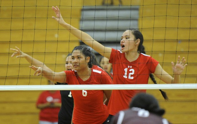 Kahuku volleyball players Carey Williams and Phoebe Grace prepared to take a serve in a win over Farrington on Sept. 7. The Red Raiders solidified their position as the Oahu Interscholastic Association front-runner with a 25-15, 25-15 home victory over two-time defending league champion Moanalua in a matchup of unbeatens Wednesday night. Bruce Asato / Honolulu Star-Advertiser.