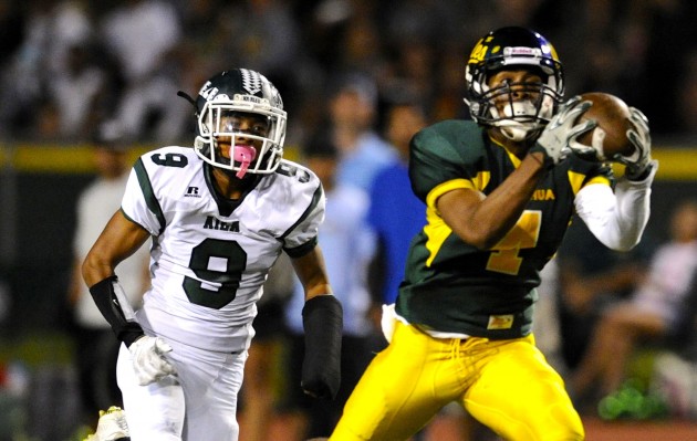 2016 October 8 SPT - HSA Photo by Bruce Asato  -Leilehua’s Charles Moku Watson hauls in a long pass for a first down behind Aiea’s Austin Mogote in the second quarter of their game at Hugh Yoshida Stadium,  Friday, Oct. 8, 2016.