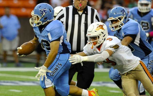 St. Francis running back Tyson Shimabukuro escaped a tackler to pick up yardage against Pac-Five. Photo by Bruce Asato/Star-Advertiser. Oct. 13, 2016