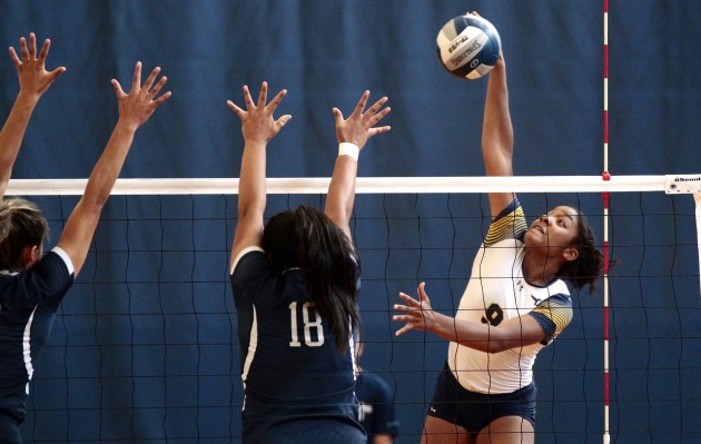 2016 October 15 SPT - HSA Photo by Jamm Aquino. Punahou outside hitter/opposite Amalia Hilliard (9) puts down a kill against Kamehameha-Kapalama outside hitter Tymane Talanoa (18) during the first set of a girls ILH volleyball game between the Punahou Buffanblu and the Kamehameha Warriors on Saturday, October 15, 2016 at Hemmeter Fieldhouse.