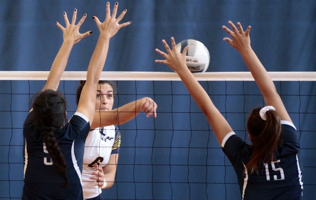  Punahou middle blocker Piikea Clemens put down a kill against Kamehameha on Saturday. Photo by Jamm Aquino/Star-Advertiser.