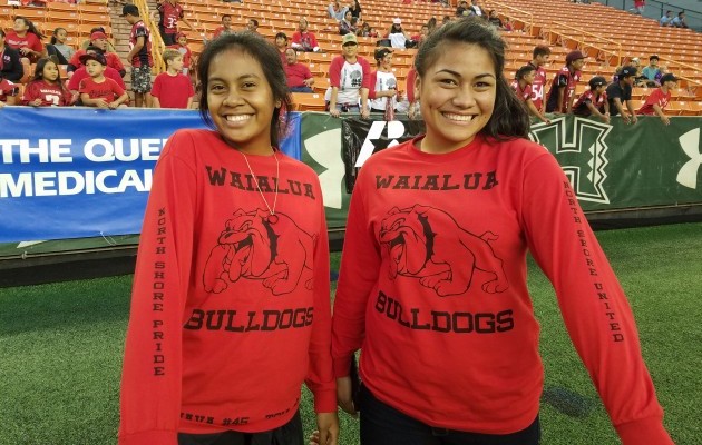 Two Waialua scorekeepers show their support for the North Shore's and its two football school. "Waialua Bulldogs" is on the front, the "Kahuku Red Raiders" is on the back and "North Shore United" is on the arm. Nick Abramo / Honolulu Star-Advertiser.
