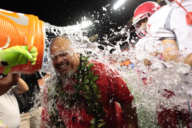 Waialua coach Lincoln Barit   is doused with water after the Bulldogs won their first OIA title since 1955. Photo by Jamm Aquino/Star-Advertiser.
