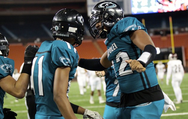 2016 October 22 SPT - HSA Photo by Jamm Aquino. Kapolei wide receiver Isaiah Ahana (11) is congratulated by quarterback Taulia Tagovailoa (12) after Ahana's touchdown during the first half of an OIA semifinal game between the Farrington Governors and the Kapolei Hurricanes on Saturday, Oct. 22, 2016 at Aloha Stadium.