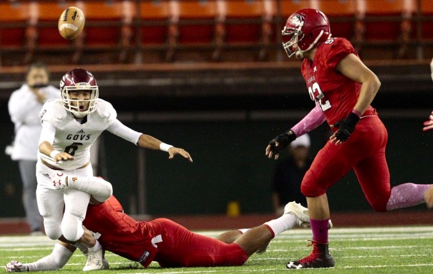 2016 October 28 SPT - HSA Photo by Jamm Aquino. Farrington quarterback Bishop Rapoza (8) fumbles the football while under pressure from Kahuku defensive lineman Aleki Vimahi (91) during the first half of the 2016 OIA Division I football championship game between the Kahuku Red Raiders and the Farrington Governors on Friday, October 28, 2016 at Aloha Stadium.