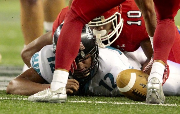 Kapolei quarterback Taulia Tagovailoa watched the ball tumble away after being strip-sacked by Kahuku's Miki Ah-You. Photo by Jamm Aquino/Star-Advertiser.