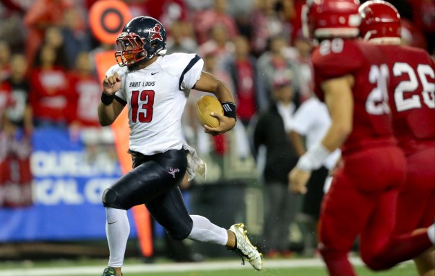 Saint Louis quarterback Tua Tagovailoa (13) hits paydirt on a touchdown during the second half of the 2016 HHSAA Open Division state championship football game between the Kahuku Red Raiders and the Saint Louis Crusaders on Saturday, Nov. 19, 2016 at Aloha Stadium.  Saint Louis won 30-14 to claim the 2016 Open Division title. HSA photo by Jamm Aquino.