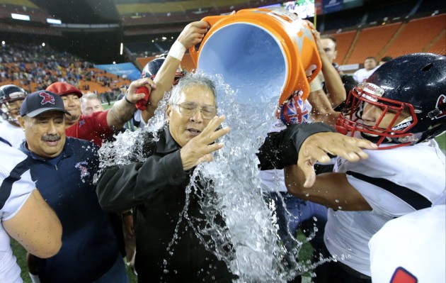 Saint Louis head coach Cal Lee is dunked with water after the 2016 HHSAA Open Division state championship football game between the Kahuku Red Raiders and the Saint Louis Crusaders on Saturday, Nov. 19, 2016 at Aloha Stadium. Saint Louis won 30-14 to claim the title. Photo by Jamm Aquino/Star-Advertiser.