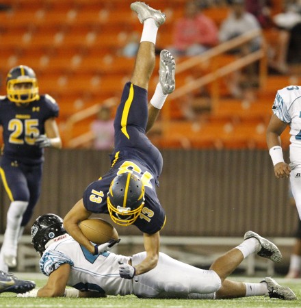 Kapolei linebacker Keanu Kelly upended Punahou receiver Keala Martinson on a play in the first half.