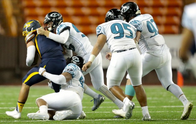 Four Kapolei defenders converged on fourth down to sack Punahou QB Stephen Barber and seal a 33-21 win in the first round of the Open Division. Photo by Jamm Aquino/Star-Advertiser.