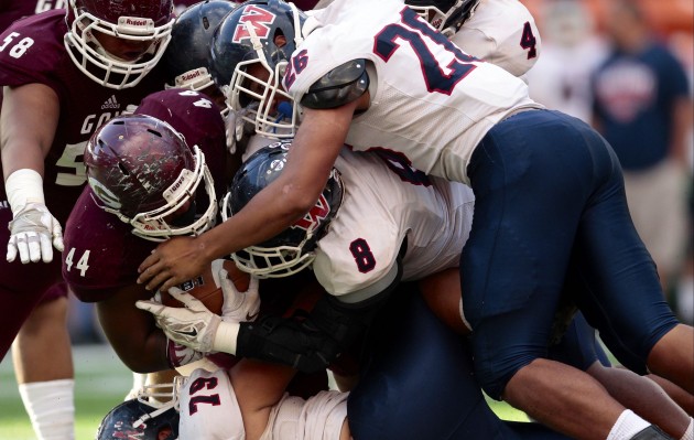 Waianae's Kanai Mauga (26) helped gang tackle Farrington running back Blessing Umaga in the first round of the Open Division state tournament. Photo by Jamm Aquino/Star-Advertiser.
