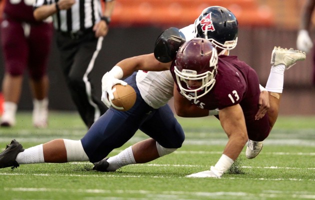 Farrington running back Challen Faamatau reached for yardage against Waianae. Photo by Jamm Aquino/Star-Advertiser.