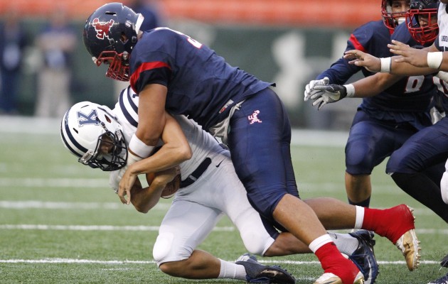 Saint Louis sophomore defensive lineman Faatui Tuitele sacked Kamehameha quarterback Thomas Yam during a game this season. Photo by Jamm Aquino/Star-Advertiser.