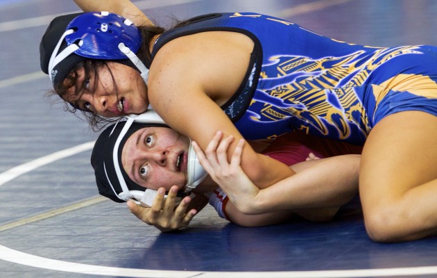 This is Tiare Ikei (top, Kaiser) beating Alexis Encinas (Lahainaluna) 6-3 in the 112 lbs. finals of the 7th Annual Pa’ani Challenge girls wrestling tournament. Dennis Oda / Star-Advertiser