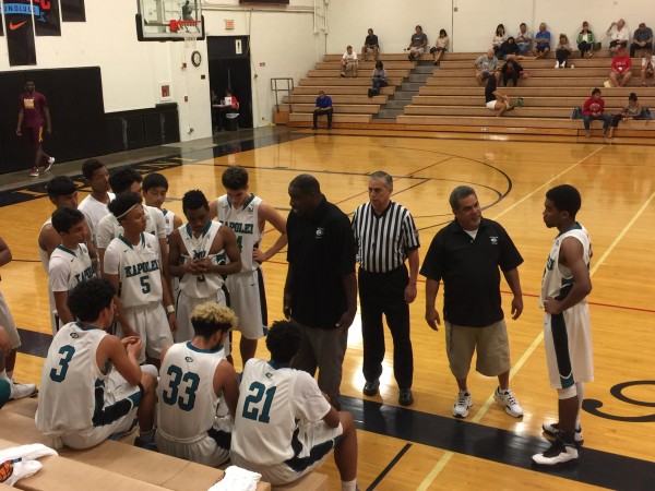 Kapolei coach Gary Ellison and his Hurricanes during a timeout against Mid-Pacific. Wednesday, Dec. 21, 2016