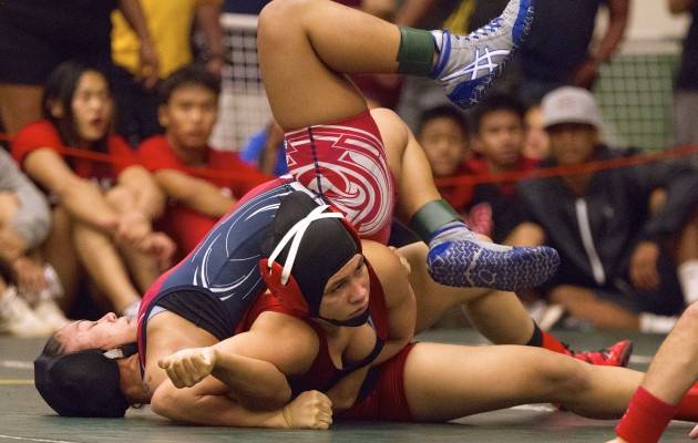 Kahuku's Teniya Alo pinned Waianae's Anuhea Hamilton in one minute during the girls 127 lb division match at the Hawaii Wrestling Officials Association Championships held at Leilehua High School on Saturday. Cindy Ellen Russell / Star-Advertiser