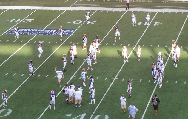 Members of the Northern California all-star team warm up prior to the start of the JPS Paradise Football Classic. Photo by Billy Hull/Star-Advertiser.