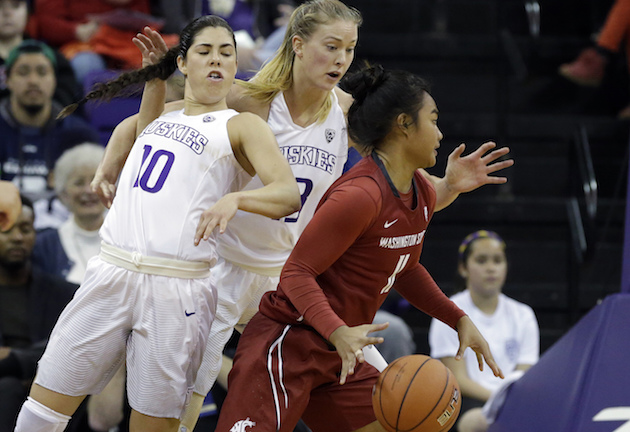 Washington State's Chanelle Molina drove past two Washington defenders in a game on Dec. 27. Associated Press photo. 
