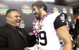 A.J. Epensa shared a laugh with Ma'a Tanuvasa after winning defensive player of the game honors at the Polynesian Bowl. Photo by Jamm Aquino/Star-Advertiser.