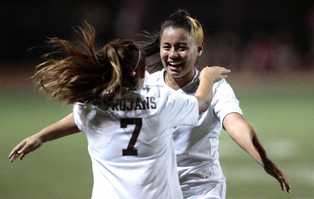 Mililani halfback Tia Rodriguez, right, embraced halfback Randi Macadangdang as time ran out in an OIA girls soccer playoff game. Photo by Jamm Aquino/Star-Advertiser.