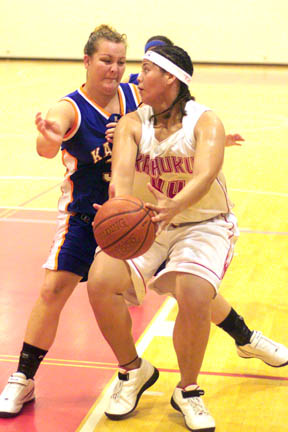 Kahuku's Latoya Wily looks to make a shot against Kalaheo's Kaiena Huihui in the third quarter at Kahuku High School.  Apr. 13, 2004. Richard Walker/Star-Bulletin