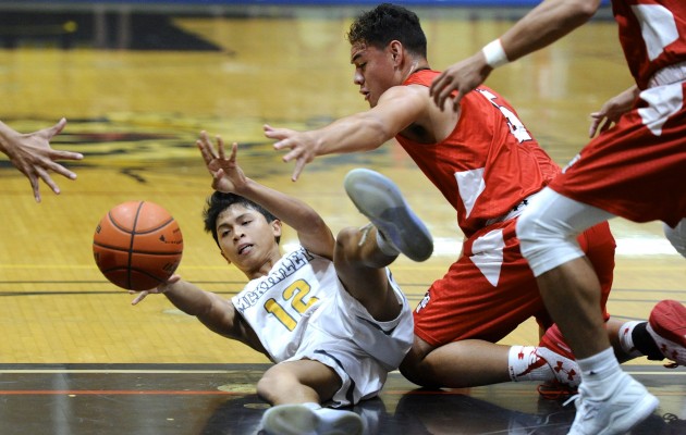 Kahuku's Kesi Ah-Hoy defended against McKinley's Jerry Coloyan at McKinley Student Council Gymnasium,, Jan. 17, 2017. Bruce Asato/Star-Advertiser