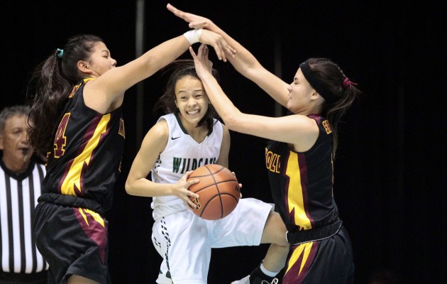 Konawaena guard Tanniya Uchida grabbed the rebound between Maryknoll forward Kehau Gilliland, left, and guard Kamalu Kamakawiwo’ole during the first half of the Division I state final between Maryknoll and Konawaena. Photo by Jamm Aquino/Star-Advertiser.