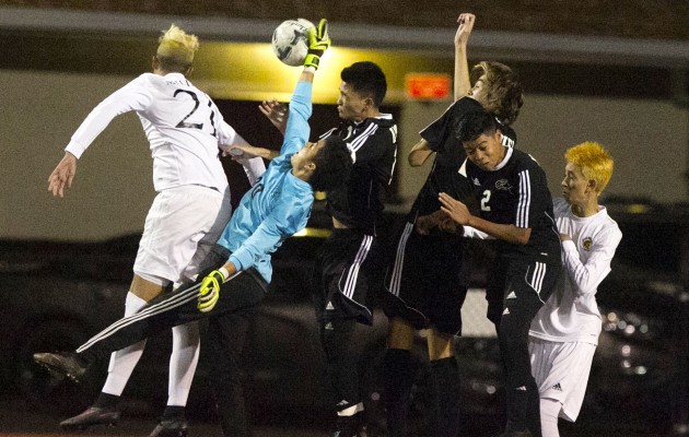 Kapolei goalkeeper Jason Patron reached out to stop a shot in the second half of the OIA title game against Mililani. Photo by Cindy Ellen Russell/Star-Advertiser.