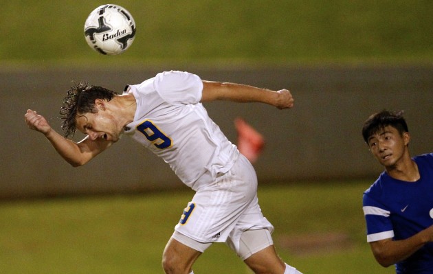 Punahou forward Duncan McKenna headed the ball away from Kaiser's Justin Takada in the Division I state final. Jamm Aquino / Star-Advertiser