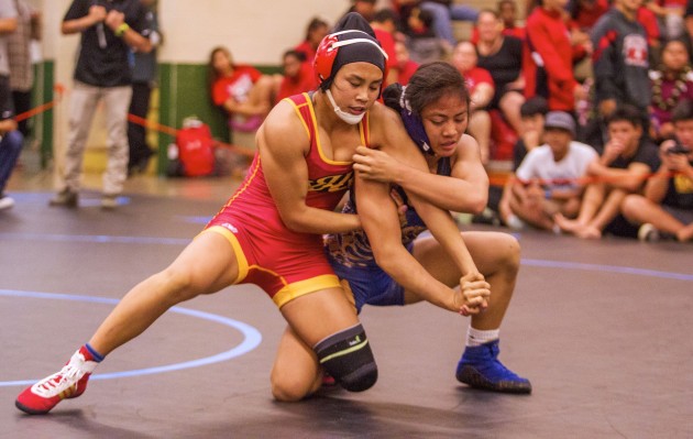 Roosevelt's Macy Higa, left, defeated Kaiser's Tiare Ikei 6-2 in the 114-pound class in the OIA championships at Leilehua on Saturday night. It was Higa's second league crown, and she denied Ikei of a second one. Dennis Oda / Honolulu Star-Advertiser.