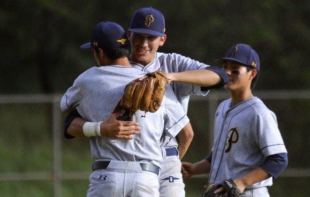 Punahou's William Bisho, shown being congratulated by shortstop Kyson Donahue after a win over Saint Louis on March 14, was the starting and winning pitcher on Friday night in a 7-3 victory over Kamehameha at Ala Wai Community Park. The Buffanblu play the Crusaders on Saturday at noon at Ala Wai. Bruce Asato / Honolulu Star-Advertiser.
