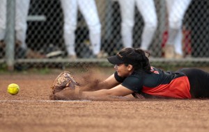 Campbell third baseman Chloe Domingo dove for a ball hit by Mililani's Jarae Keliikoa and just missed it. The ball hit her glove in fair territory and bounced foul, and Keliikoa was awarded an infield hit. Jamm Aquino / Honolulu Star-Advertiser. 