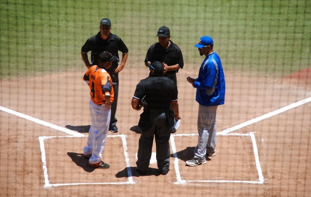 Campbell coach Rory Pico and Kaiser coach Kila Ka'aihue met at home plate pregame. Photo by Jerry Campany/Star-Advertiser.
